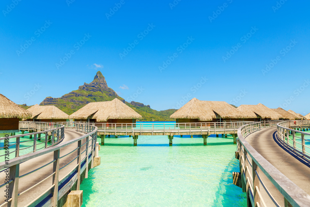 Over water villas on a tropical lagoon of Bora Bora Island, Tahiti, French Polynesia Over water villas on a tropical lagoon of Bora Bora Island, Tahiti, French Polynesia