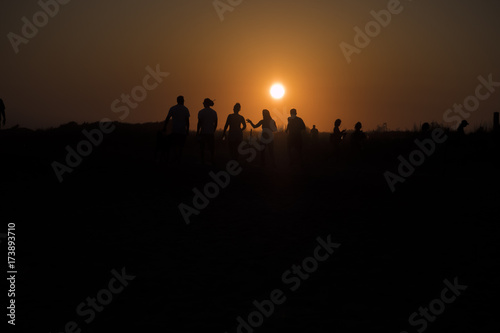 People walking at sunset