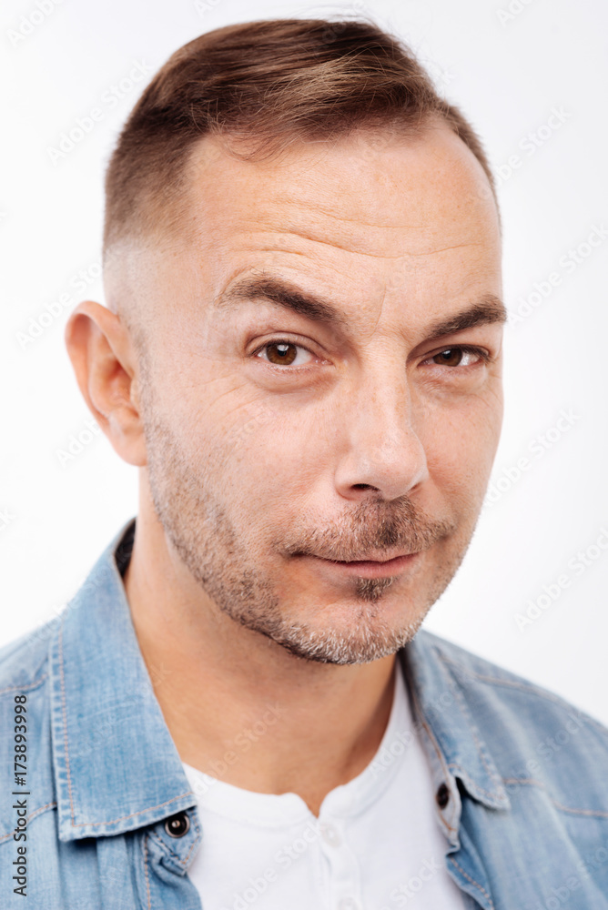 Portrait of bristled young man raising eyebrows Portrait of bristled young man raising eyebrows