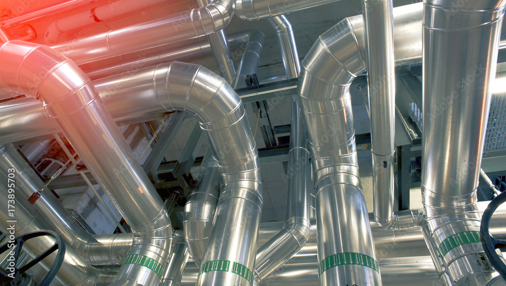 Equipment, cables and piping as found inside of a modern industrial power plant