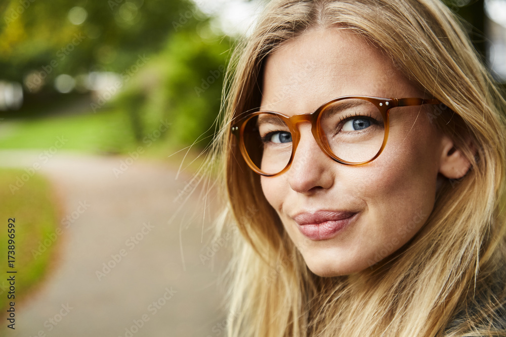 Portrait of beautiful young woman in glasses in park Portrait of beautiful young woman in glasses in park
