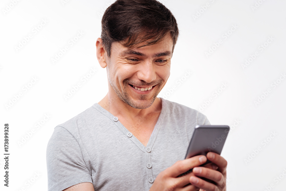 Happy handsome man reading text message with smile Happy handsome man reading text message with smile
