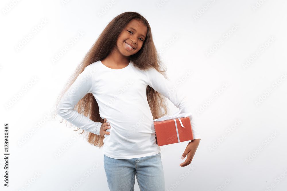 Smiling pre-teen girl posing with a present box Smiling pre-teen girl posing with a present box