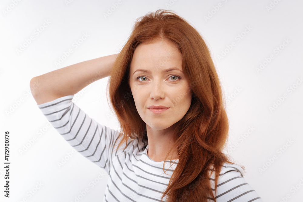 Charming woman posing with her hand on back of head Charming woman posing with her hand on back of head