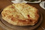 Hot tortilla with cheese. Khachapuri, bread baked with cheese. A dish of Caucasian cuisine. Photography in a Restaurant