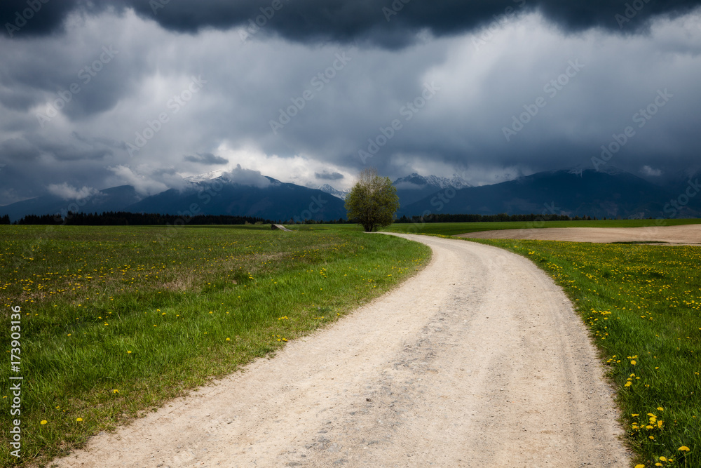 Road to stormy mountains