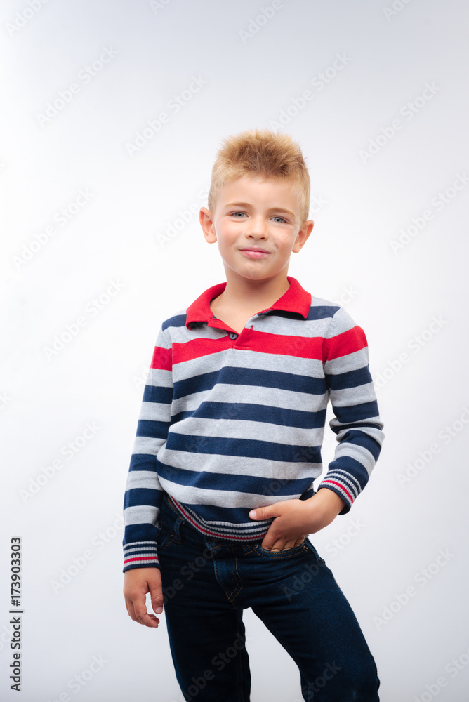 Fair-haired little boy posing with hand in pocket