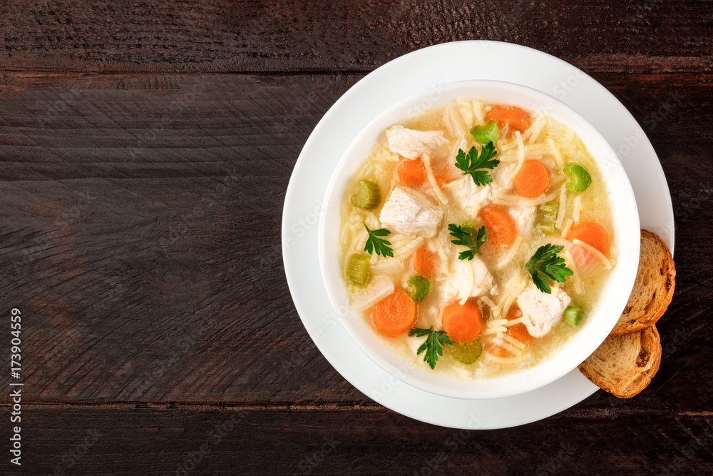 Chicken soup with noodles, overhead photo with copyspace