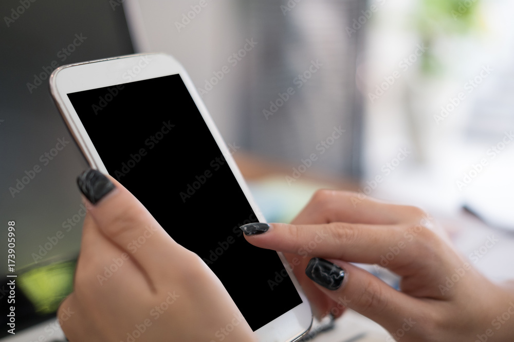 businesswoman use mobile phone at workplace. young woman texting message on smart phone at office. freelancer use cellphone for online network connection businesswoman use mobile phone at workplace. young woman texting message on smart phone at office. freelancer use cellphone for online network connection