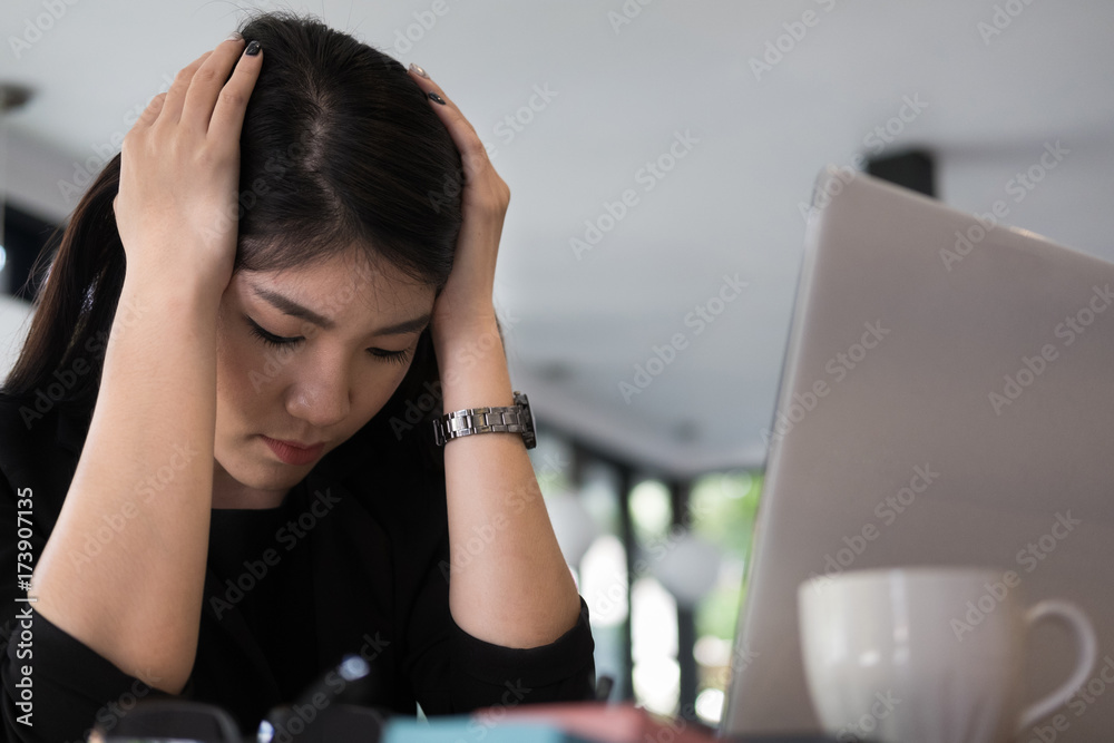 Fototapeta premium tired businesswoman with hand on head at office. frustrated young woman with headache at workplace. exhausted startup in depression after long work. overwork, stress, fatigue concept