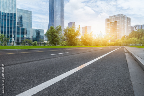 city empty traffic road with cityscape in background.