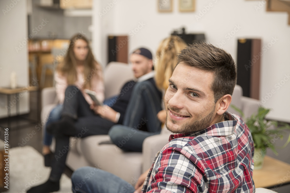 Portrait of handsome guy amongst group of friends