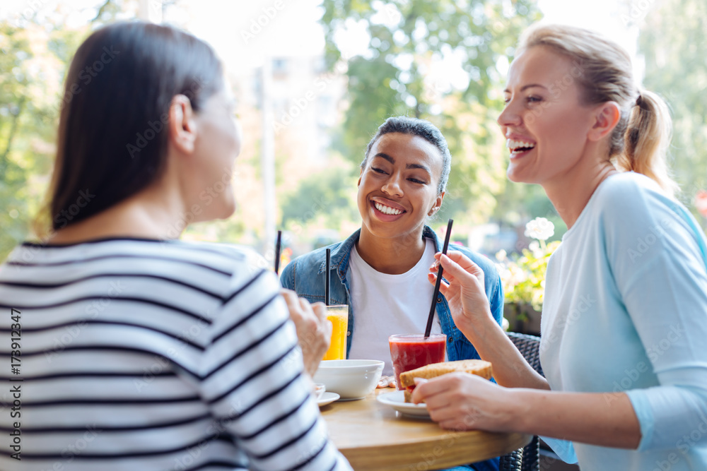 Female friends remembering good old days at lunch Female friends remembering good old days at lunch