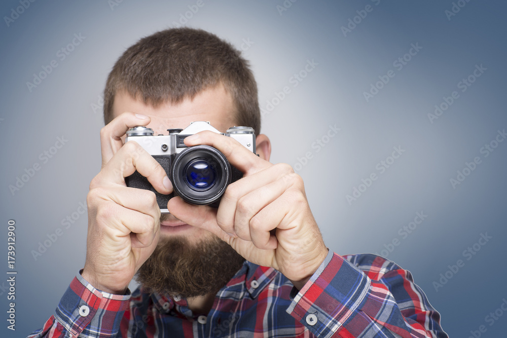 Hipster fashion photographer man holding retro camera Hipster fashion photographer man holding retro camera
