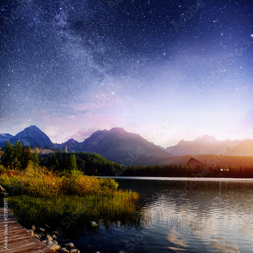 Fantastic starry sky and the milky way over a lake in the park High Tatras. Shtrbske Pleso  Slovakia  Europe