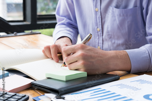 businessman write note on notebook at office desk. man write memo with fountain pen at workplace.