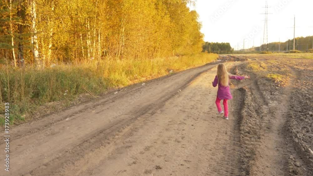 Happy young girl blowing soap-bubbles, twisting and turning around. Outdoor autumn. Slow motion Happy young girl blowing soap-bubbles, twisting and turning around. Outdoor autumn. Slow motion