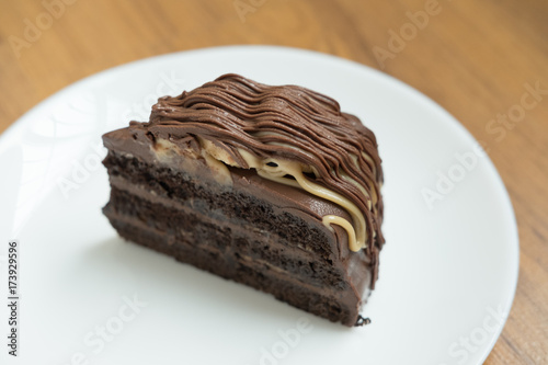 banana caramel chocolate cake. tasty deliciouse dessert on white plate. homemade bakery pastry photo