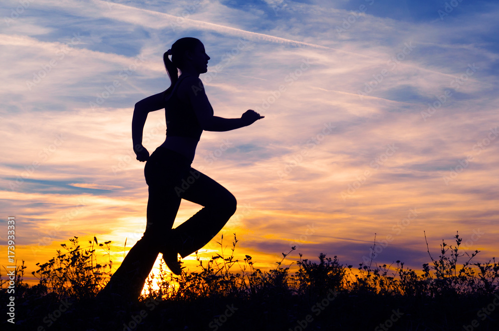 Silhouette of young woman running in nature Silhouette of young woman running in nature