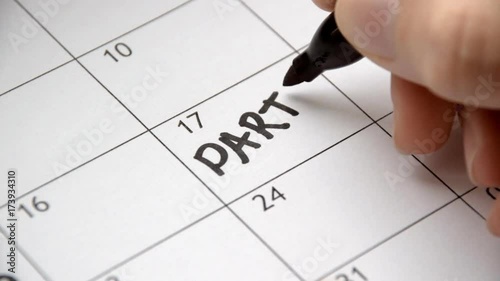 Writing PARTY on calendar with a black marker