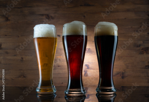 Three glasses of different colored beer