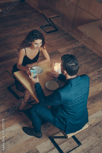 man presenting gift to girlfriend