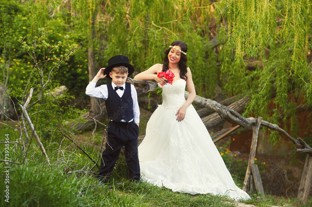 the bride and the little boy dressed gentleman in the Park