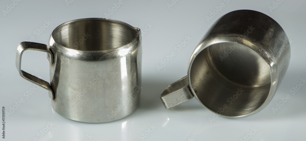 two metal nickel-plated cups on a white background. two metal nickel-plated cups on a white background.