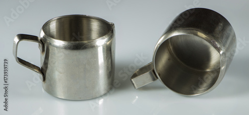 two metal nickel-plated cups on a white background.