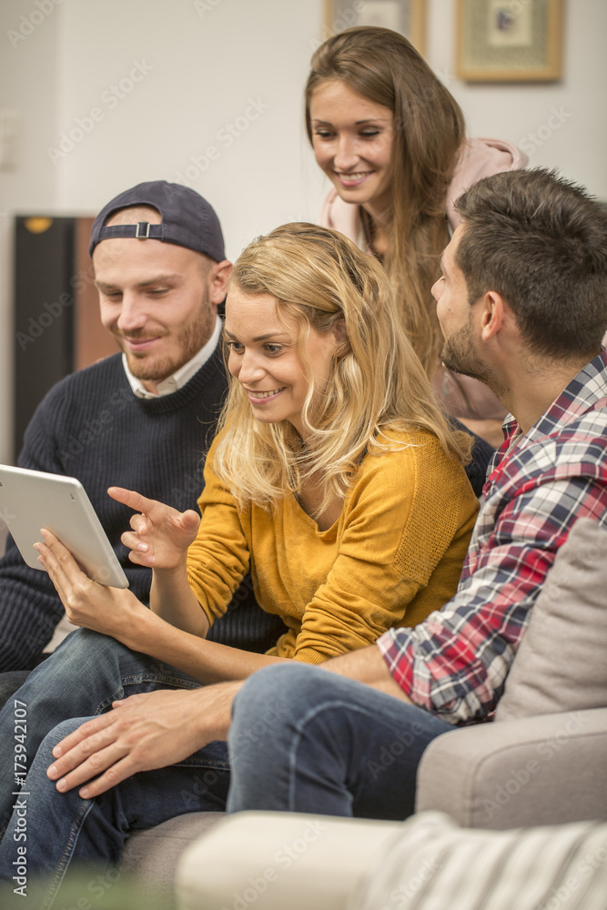 roommates choosing tv program on digital tablet roommates choosing tv program on digital tablet