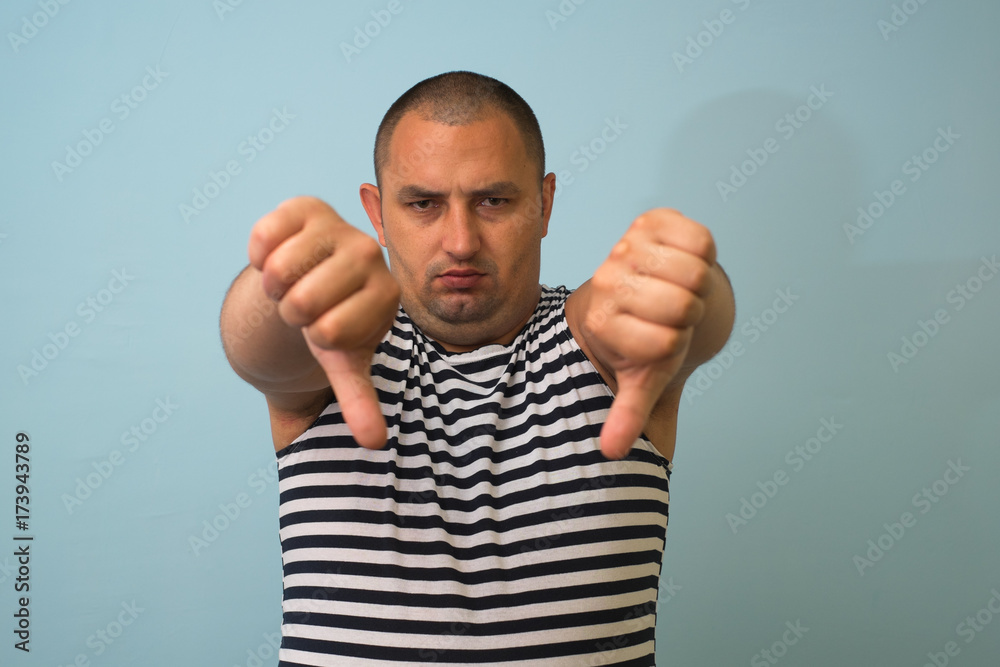 Naklejka premium man showing a thumb down gesture