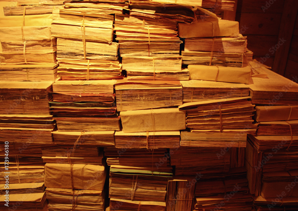 Background from a set of the piled old books with the turned yellow pages Background from a set of the piled old books with the turned yellow pages