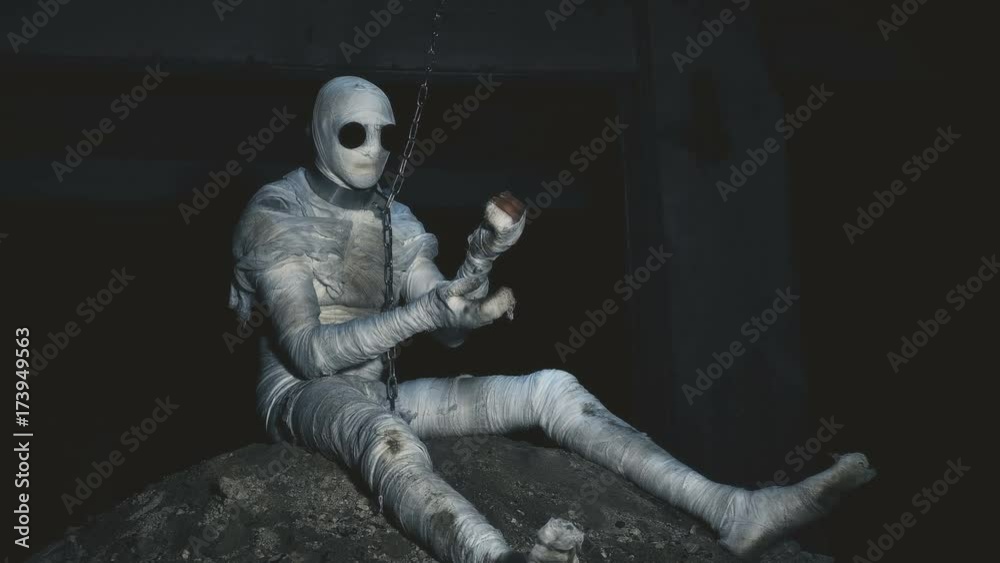people being in bandages in a dark, abandoned building on the chain in custody people being in bandages in a dark, abandoned building on the chain in custody