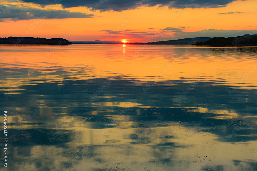 sunset over the transylvania lake in Umbria Italy intense late summer colors in the pier