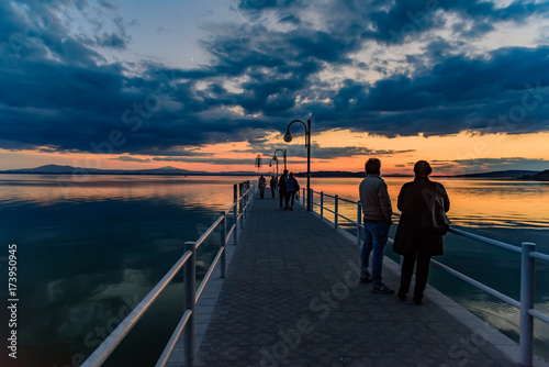 sunset over the transylvania lake in Umbria Italy intense late summer colors in the pier