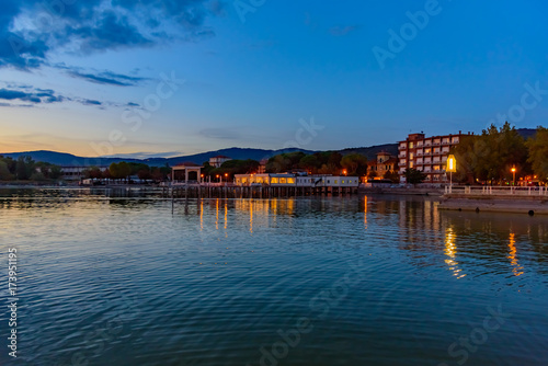 sunset over the transylvania lake in Umbria Italy intense late summer colors in the pier