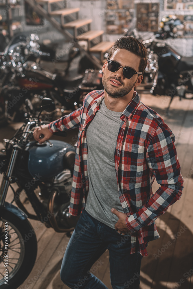 motorcyclist in sunglasses with classic motorbike