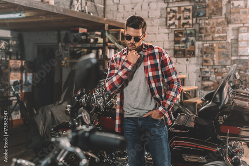 motorcyclist in sunglasses with motorbike