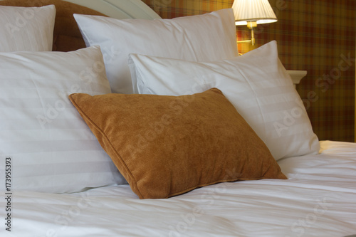 Pillows on bed in hotel roo...