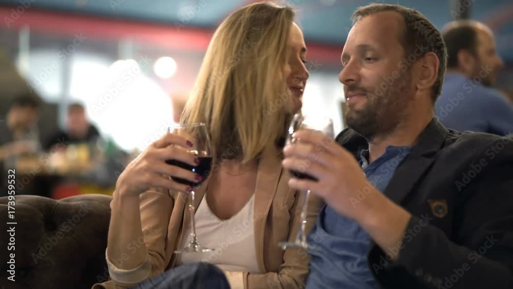 Happy couple talking and drinking red wine in cafe
Happy couple talking and drinking red wine in cafe