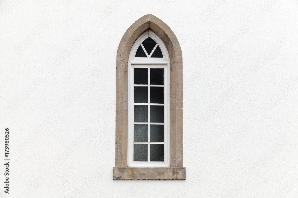 Window in white stone wall, Gothic Revival
