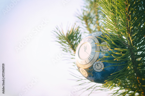 Glass ball, Christmas decoration with a clock on a Christmas tree, processing under a vintage photo, texture added,