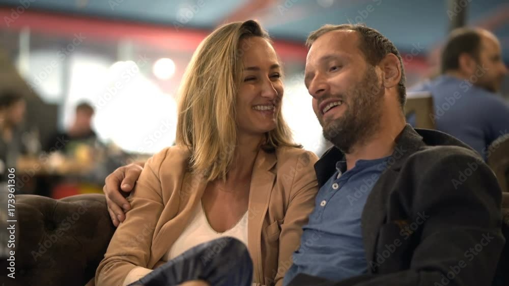 Happy, young couple talking sitting in cafe
Happy, young couple talking sitting in cafe
