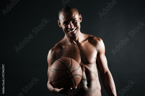 Smiling young afro american basketball player holding ball © Drobot Dean