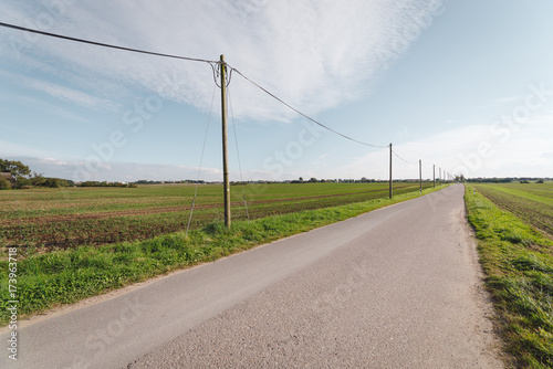 road by field against sky