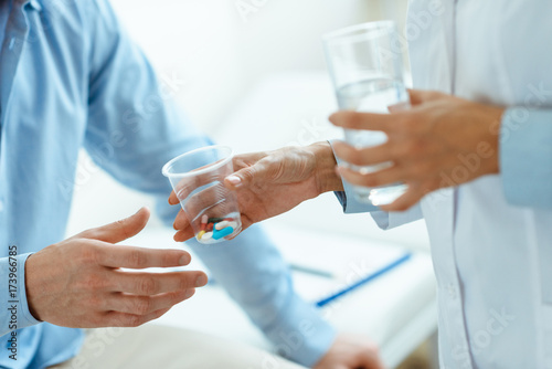 Woman handing pills to man