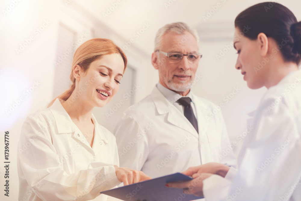 Attractive blonde female pointing at mistake in text Attractive blonde female pointing at mistake in text