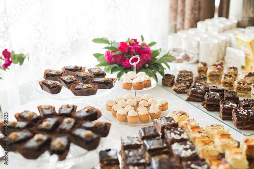 Delicious sweets on wedding candy buffet with desserts  cupcakes