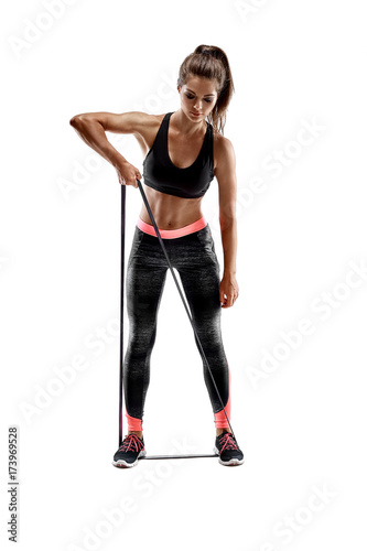 Woman exercising fitness resistance bands in studio silhouette isolated on white background © nazarovsergey