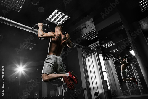 Quadro su tela Strong man with tatoo working in gym